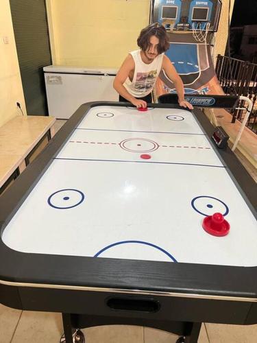 a man playing a game on a ping pong table at חלומות בגבעה Dreams On The Hill in El ‘Affūle