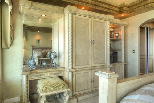 a bedroom with a large cabinet with a bench in it at La Mansión Residency Suites Ensenada in Ensenada