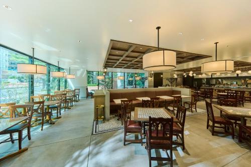 a restaurant with tables and chairs and windows at The Royal Park Hotel Ginza 6-Chome in Tokyo