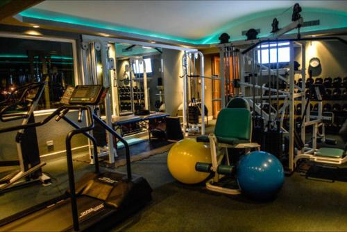 a fitness room with a gym with machines and weights at La Mansión Residency Suites Ensenada in Ensenada