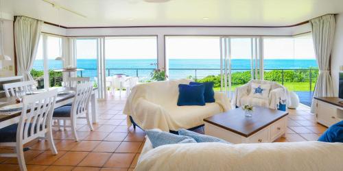 a living room with a view of the ocean at wisteria Ocean Nakijin in Nakijin