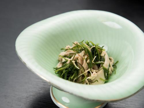 a white bowl filled with food on a table at Itoya Ryokan in Nanyo