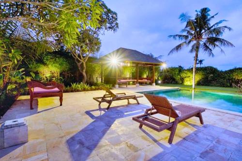 a patio with two chairs and a swimming pool at Sinena 1 BR Private Pool Villa JU28 in Ketewel