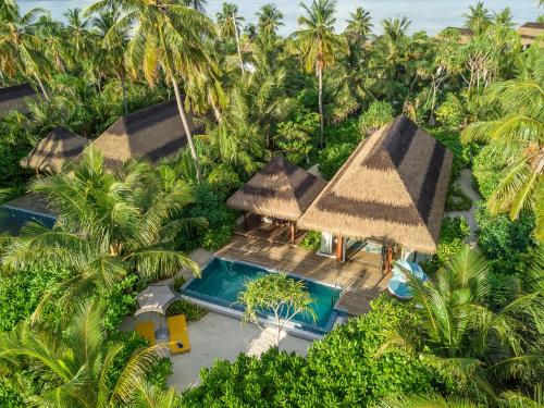 an aerial view of a resort with a pool and palm trees at Pullman Maldives Maamutaa - All-Inclusive Resort - 50 percent off Transfers in Maamutaa