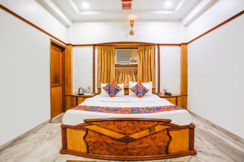 a bedroom with a large bed in a room at FabHotel Rest & Peace in Ahmedabad