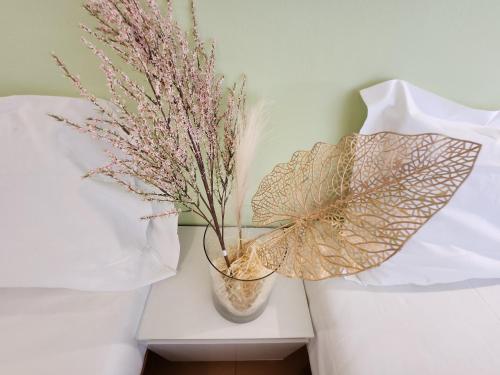 a vase with flowers in it sitting on a table at Hotel Petit in Silvi Marina