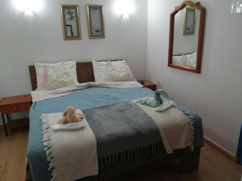 a bedroom with a bed with a doll on it at Hotel Fotini in Kamena Vourla
