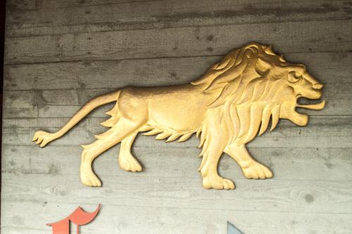a wooden carving of a lion on a wall at Landgasthof Lowen in Sulgen