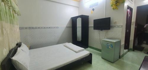 a small room with a bed and a tv at An Bình 66 in Can Tho