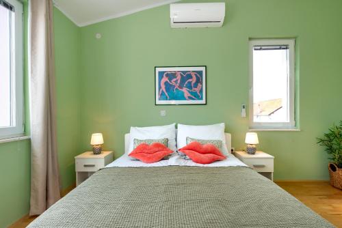 a bedroom with a bed with red pillows on it at KAIROS in Bilice