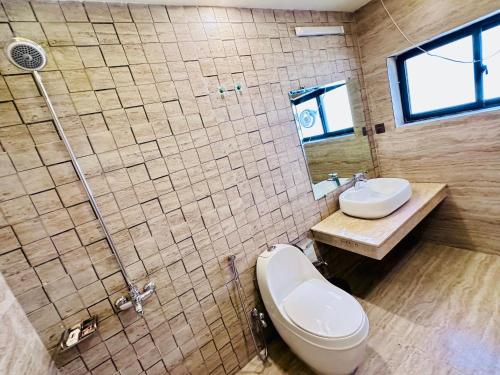 a bathroom with a toilet and a sink and a shower at Blue Moon Residency 1 in Islamabad