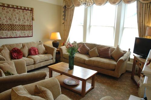 a living room with couches and a coffee table at The Bebington in Bebington