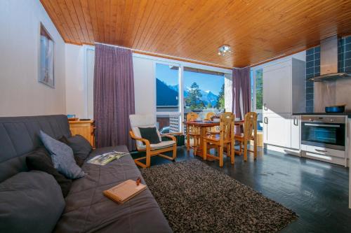 a living room with a couch and a table at Residence de Lognan- Les Jorasses 26 - Happy Rentals in Chamonix-Mont-Blanc