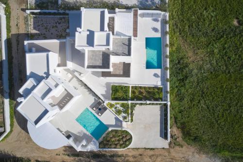 an aerial view of a white house with a swimming pool at Maestro Villas Naxos in Naxos Chora