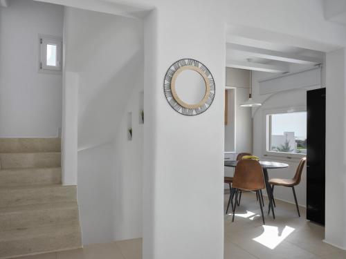 a dining room with a mirror and a table at Maestro Villas Naxos in Naxos Chora