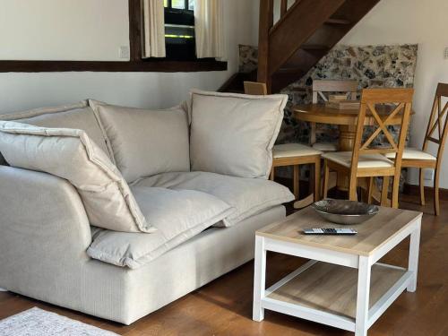 a living room with a couch and a table at Garden Cottage in Henley on Thames