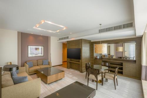 a living room with a couch and a table at Four Points by Sheraton Al Ain in Al Ain