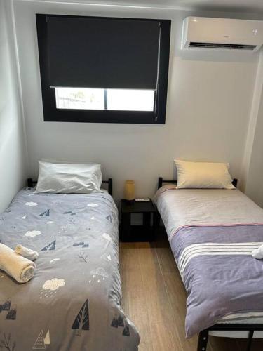Ένα ή περισσότερα κρεβάτια σε δωμάτιο στο Murray Lane Cozy Hideaway