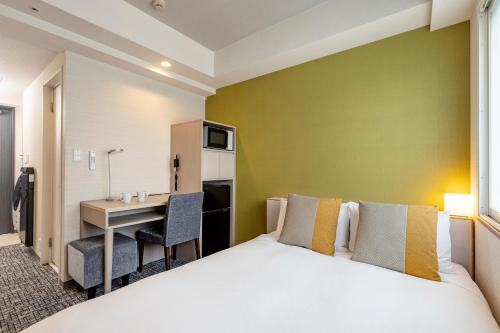 a hotel room with a bed and a desk at Tokyu Stay Tsukiji - Tokyo Ginza Area in Tokyo