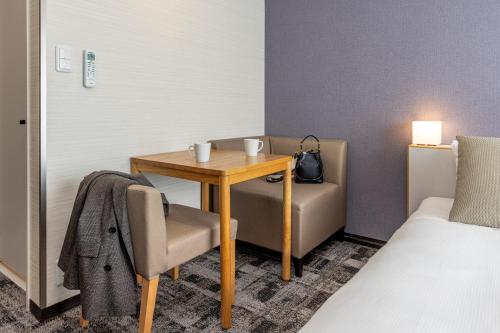 a room with a table and a chair and a bed at Tokyu Stay Tsukiji - Tokyo Ginza Area in Tokyo