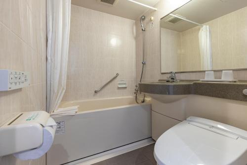 a bathroom with a white toilet and a sink at Tokyu Stay Tsukiji - Tokyo Ginza Area in Tokyo