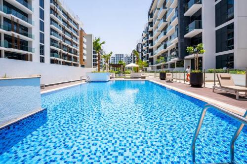 a swimming pool in the middle of a building at Zapbed House - Modern Studio in Azizi Riviera 27 Meydan One in Dubai