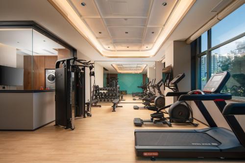 einen Fitnessraum mit Laufbändern und Kardiogeräten in einem Zimmer in der Unterkunft Hilton Garden Inn Beijing West Railway Station in Peking