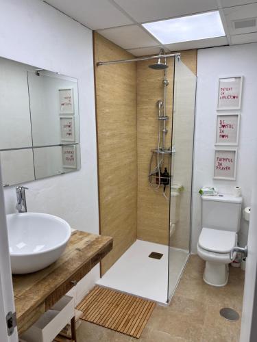 a bathroom with a sink and a shower and a toilet at Bambu in Carboneras