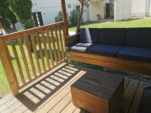 a blue couch sitting on a wooden deck at Camping Adria - Glamping Tent in Ankaran