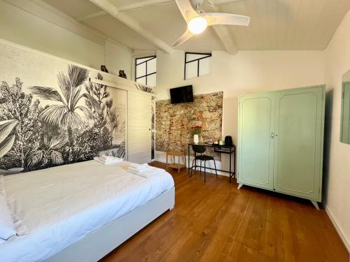 a bedroom with a bed and a desk in it at La Matilde in Viareggio