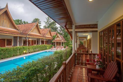 an external view of a villa with a swimming pool at Bangtao Village Resort - SHA in Bang Tao Beach