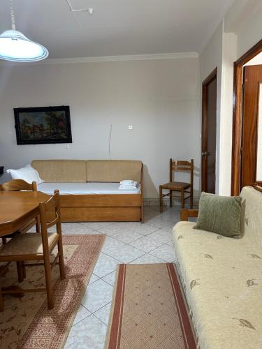 a living room with a bed and a table at Kate's Guesthouse in Theologos