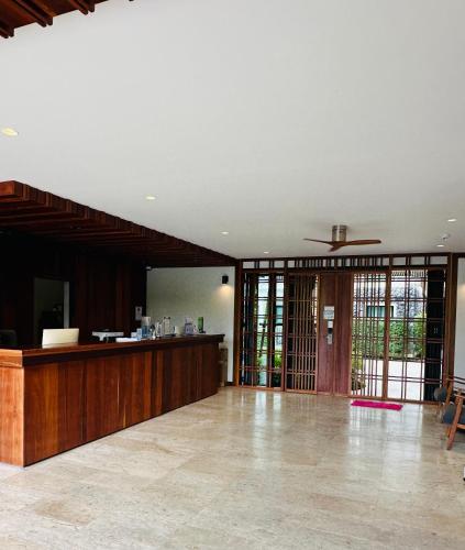 an empty lobby with a reception desk in a building at Title V in Rawai Beach