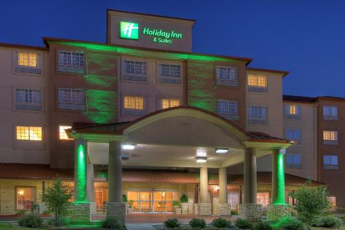 a hotel building with green lights in front of it at Holiday Inn & Suites Albuquerque Airport by IHG in Albuquerque