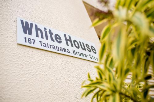 a white house sign on the side of a building at White House in Uruma