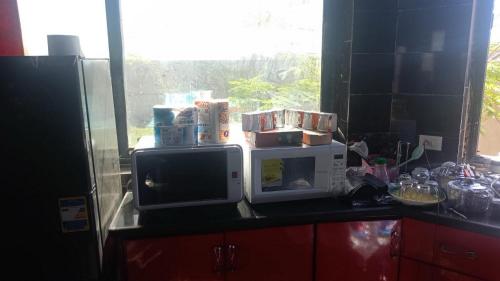 a kitchen counter with two microwaves on top of a microwave at Villa Mostafa Sadek, Swimming pool, Tennis & Squash - Borg ElArab Airport Alexandria in Borg El Arab