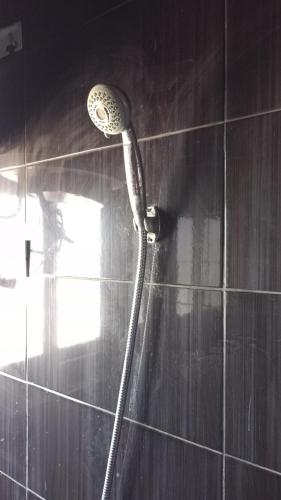 a shower with a shower head in a bathroom at Villa Mostafa Sadek, Swimming pool, Tennis & Squash - Borg ElArab Airport Alexandria in Borg El Arab