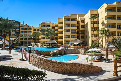 a resort with a swimming pool and some buildings at Eagles down town Zahabia &Beach Resort in Hurghada
