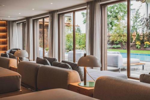 a living room with couches and a pool at Bergresort Zugspitze Ehrwald by ALPS RESORTS in Ehrwald