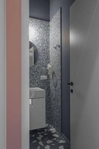 a bathroom with a toilet and a sink and a shower at Resume apartments in Kaunas