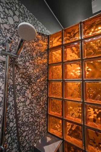 a bathroom with a shower with a large glass wall at Resume apartments in Kaunas