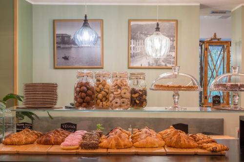 a bakery with a bunch of pastries on a shelf at Avenue Boutique Hotel in Como