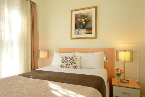 Postel nebo postele na pokoji v ubytování Parc Suites Hotel