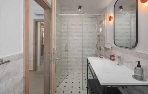 a bathroom with a shower with a sink and a mirror at Villa Paulina by SeeAdria Agency in Buje