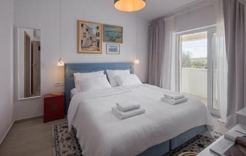 a bedroom with a large bed with towels on it at Villa Paulina by SeeAdria Agency in Buje