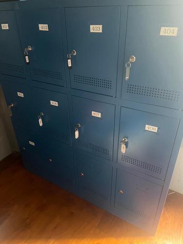 a bunch of blue lockers in a room at Hostel Bedgasm in Tokyo
