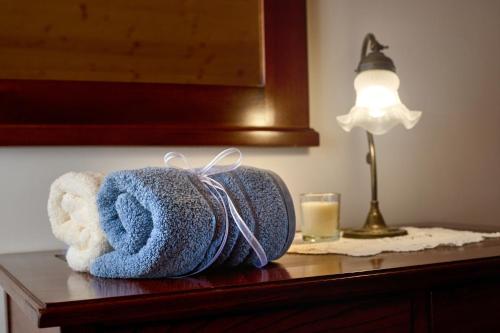 a towel sitting on a table next to a lamp at Four-Bedroom Villa Bajer in Stari Trg pri Ložu