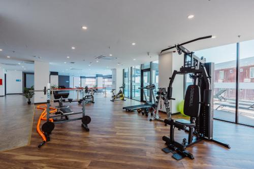a gym with treadmills and machines in a building at Hotel Navi in Batumi