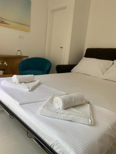 two white towels sitting on top of a bed at Brela - room for two in Brela