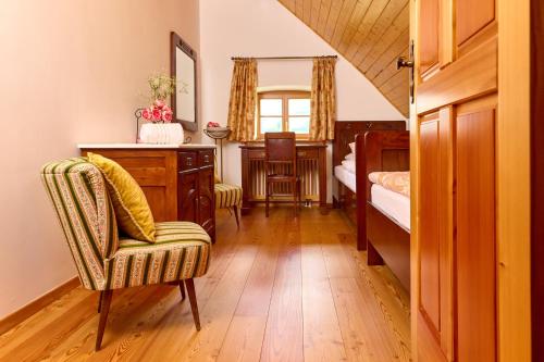 a bedroom with a desk and a bed and a chair at Four-Bedroom Villa Bajer in Stari Trg pri Ložu